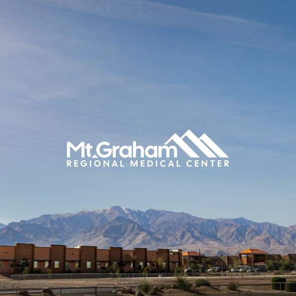 Mt. Graham Regional Medical Center wordmark over the Mt. Graham range and hospital campus